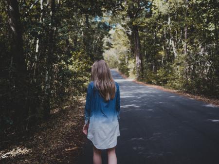 Woman Wearing Blue and White Long-sleeved Shirt Walking Near Tree