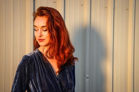 Woman Wearing Blue Top Looking Downward