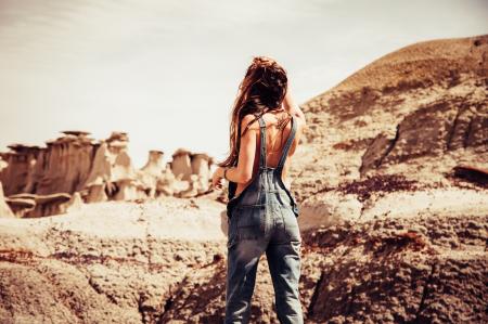 Woman Wearing Blue-washed Overalls Near Rock Formation