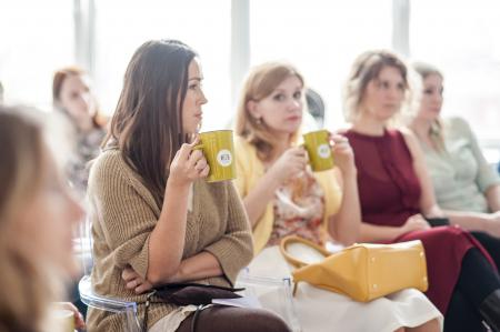 Woman Wearing Brown Corduroy Coat Holding Mug While Sitting on Chair