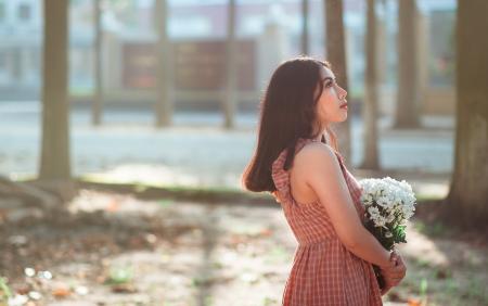 Woman Wearing Brown Sleeveless Dress Carrying White Flower Bouquet