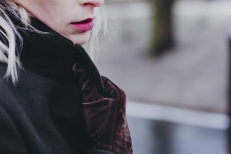 Woman Wearing Brown Suede Gloves Holding Her Coat