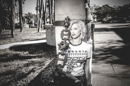 Woman Wearing Crew-neck Shirt Leaning Against the Post