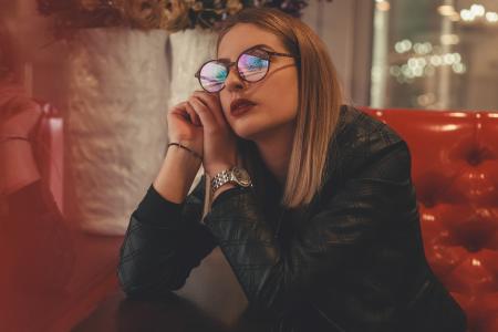 Woman Wearing Eyeglasses Sitting Down
