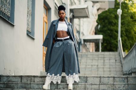 Woman Wearing Gray Coat and White Crop Top on Staircase