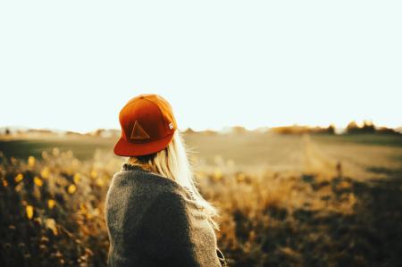 Woman Wearing Gray Shirt With Cap Under White Sky