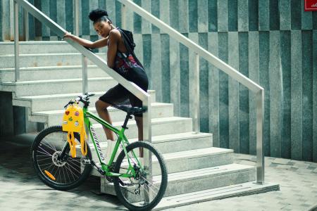 Woman Wearing Gray Sleeveless Hooded Top Standing in the Stair