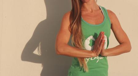 Woman Wearing Green Shirt Standing Beside Wall