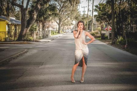 Woman Wearing Grey and Beige Dress Standing on Center of Street