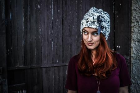 Woman Wearing Maroon Short-sleeved Shirt and White and Grey Knit Cap