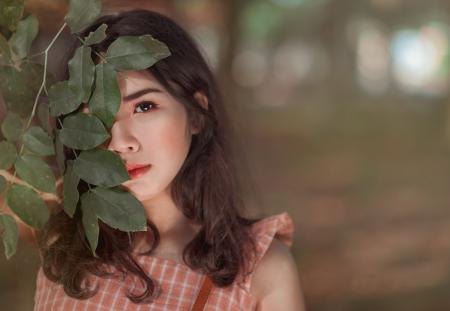 Woman Wearing Pink Sleeveless Top Behind Leaves