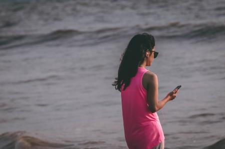 Woman Wearing Pink Tank Top Standing Near Sea Shore