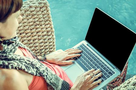 Woman Wearing Pink Top With Macbook on Lap
