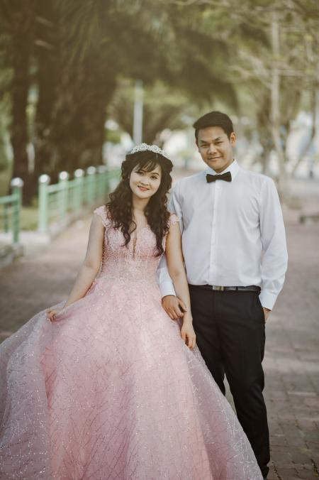 Woman Wearing Pink Wedding Gown Standing Next to Man Wearing White Dress Shirt