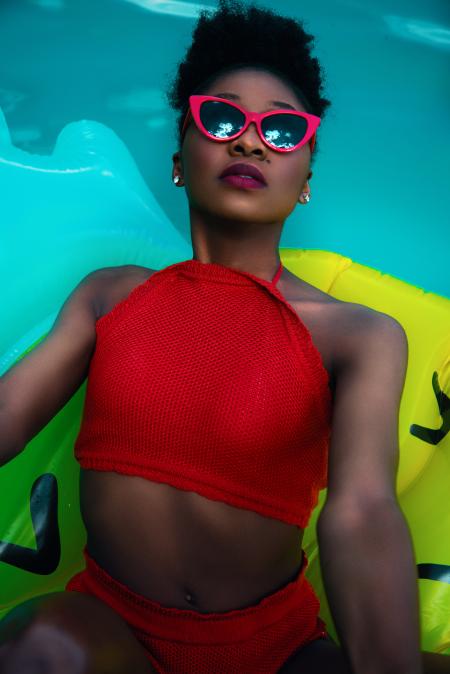Woman Wearing Red Bikini on Float Talking Photo on Pool