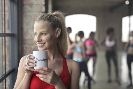 Woman Wearing Red Tank Top Holding White Ceramic Mug