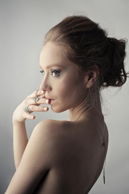 Woman Wearing Silver-colored Earrings Posing