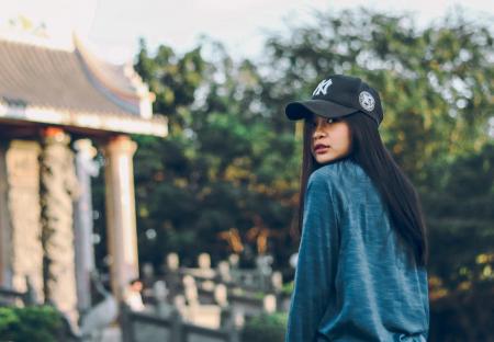 Woman Wearing Sweater And Baseball Cap
