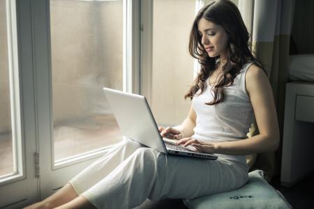 Woman Wearing Tank Top Sitting by the Window