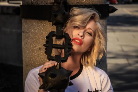 Woman Wearing White Crew-neck Shirt Holding Black Weapon