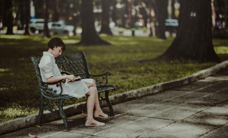 Woman Wearing White Dress Sitting on Bench