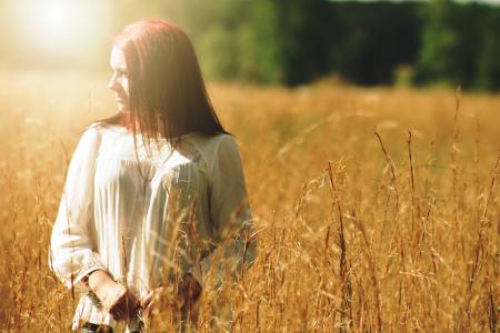 Woman Wearing White Long Sleeved Shirt Standing in Brown Grass Field