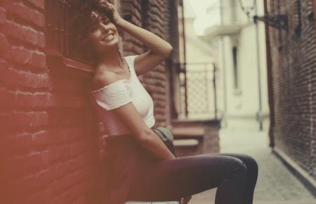 Woman Wearing White Off-shoulder Shirt and Blue Denim Jens