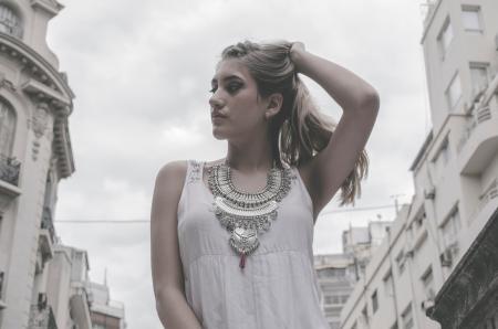 Woman Wearing White Tank Top Holding Hair Pose