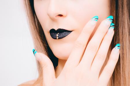 Woman With Black Lipstick and Teal Nail Polish