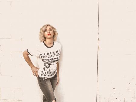 Woman With Blond Hair Wearing Whit Crew Neck Shirt and Gray Jeans