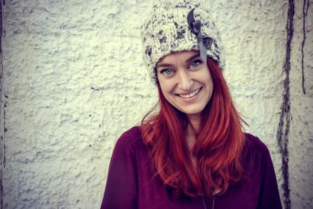 Woman With Red Hair Wears Purple Top