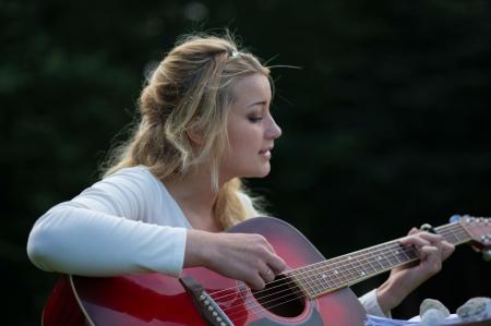 Woman's Playing Red and Black Wooden Acoustic Guitar