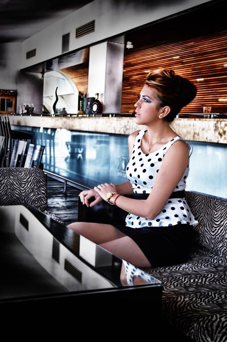 Women in White and Black Dress Sitting on Couch