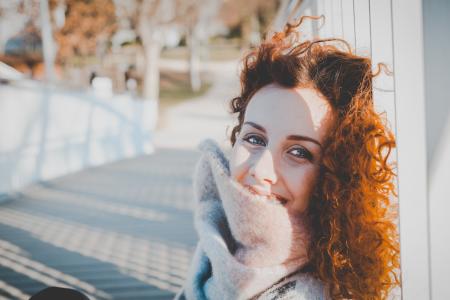 Women Leaning on White Wooden Fence Wearing Gray Furred Top