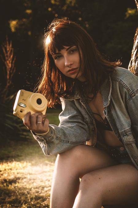 Women Wearing Blue Denim Jacket Holding Yellow Fujifil Instax Mini 8