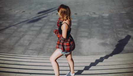 Women Wears Red and Black Shirt and Pair of White Shoes on Stair Photo