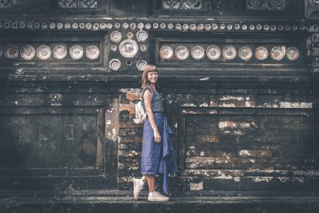 Women's Blue Sleeveless Shirt Near Gray Concrete Wall