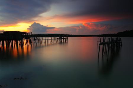 Wooden Boardwalk on Body of Water during Dawn