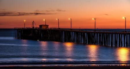 Wooden Dock on Sea Shore With Light Post during Sunset