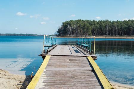 Wooden pier with fences against the backdrop of the lake