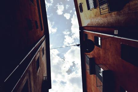 Worm's Eyeview Photography of Brown Concrete Building and White Clouds