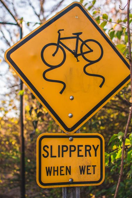 Yellow and Black Slippery When Wet Road Sign Board