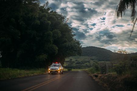 Yellow and White Police Car Lone on the Road