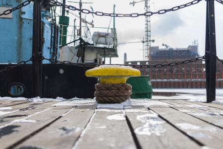 Yellow Anvil Beside Green Boat