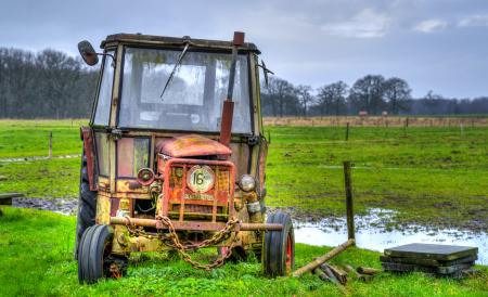 Yellow Farm Equipment on Green Grass Field