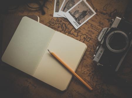 Yellow Pencil on White Book Near Camera