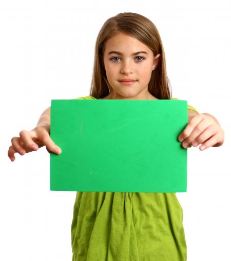 Young girl holding a blank green sign