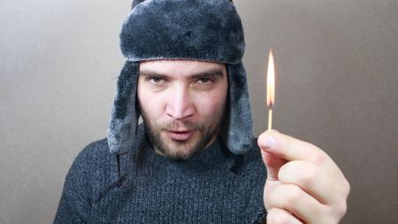 Young man holding a match