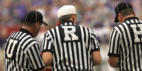 3 Referees Standing on Field