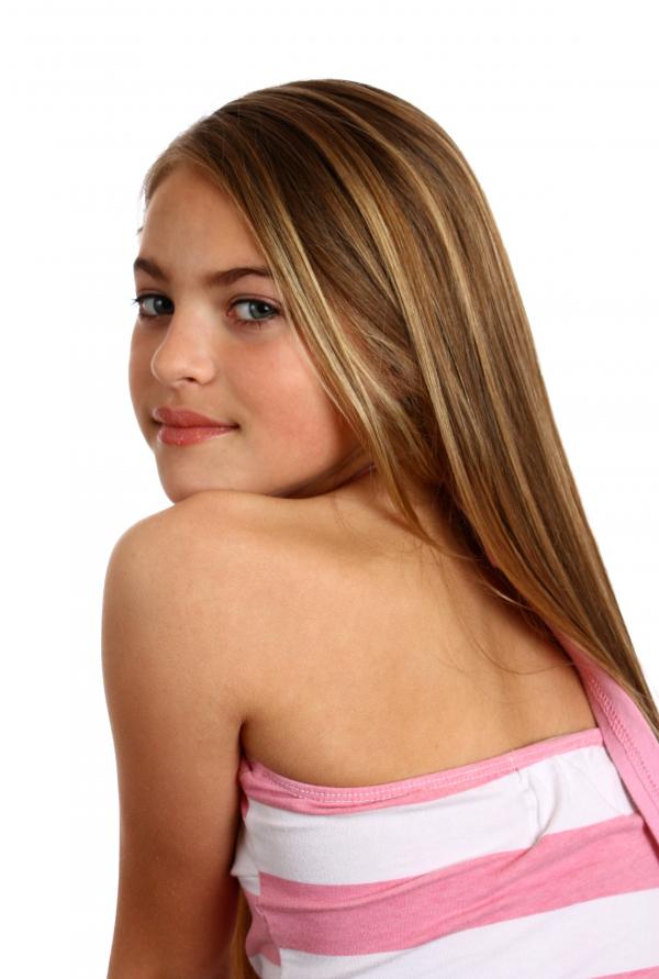 A beautiful young girl posing on white